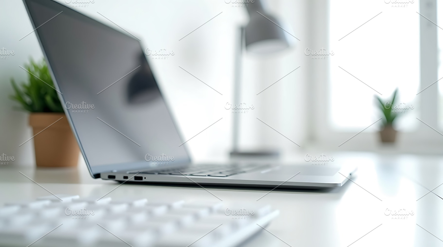 Laptop and keyboard on white desk, a Technology Photo by Artonix