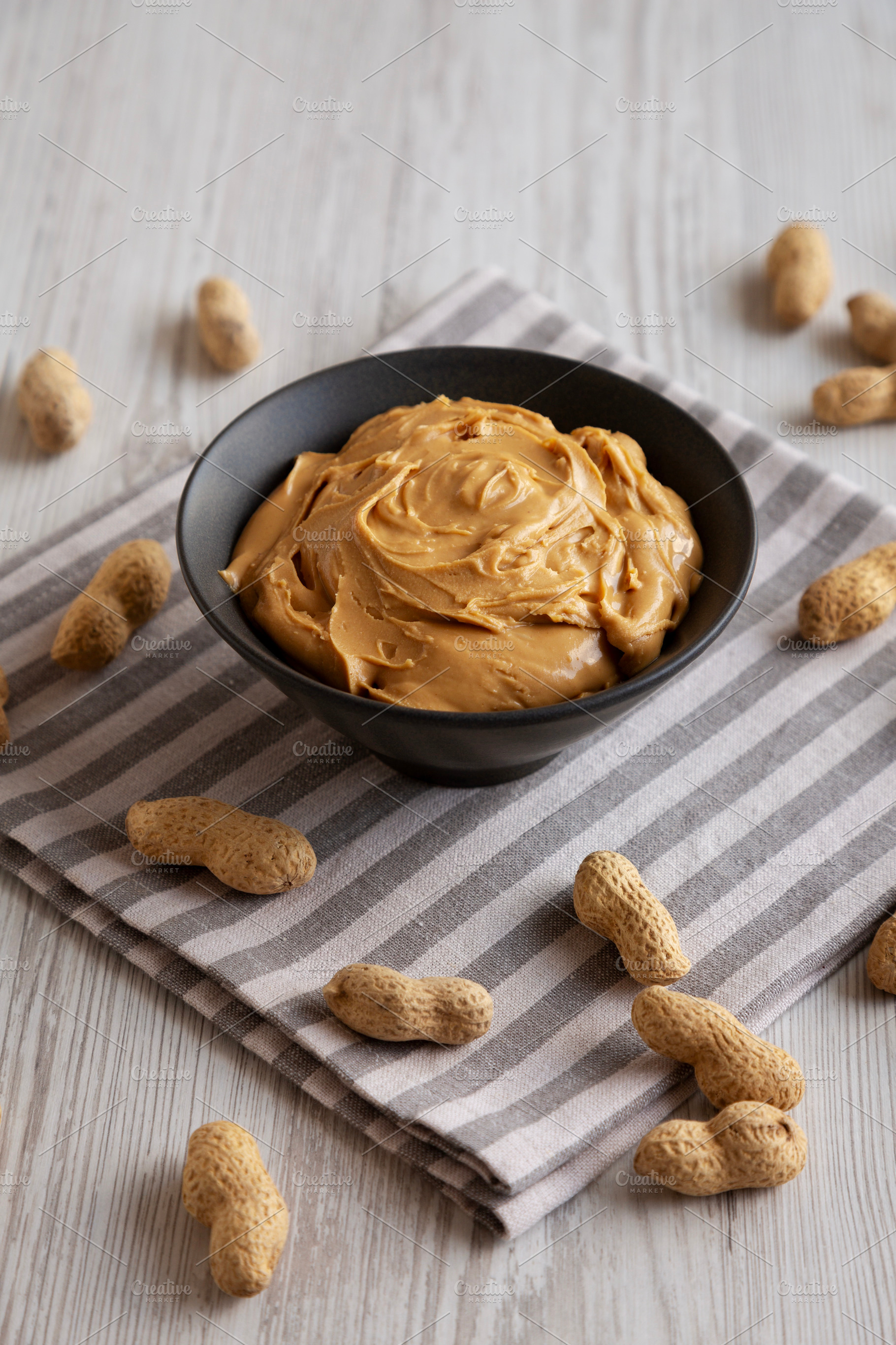 Organic Creamy Peanut Butter in a Bowl, side view., a Food & Drink Photo by LiudmylaChuhunova