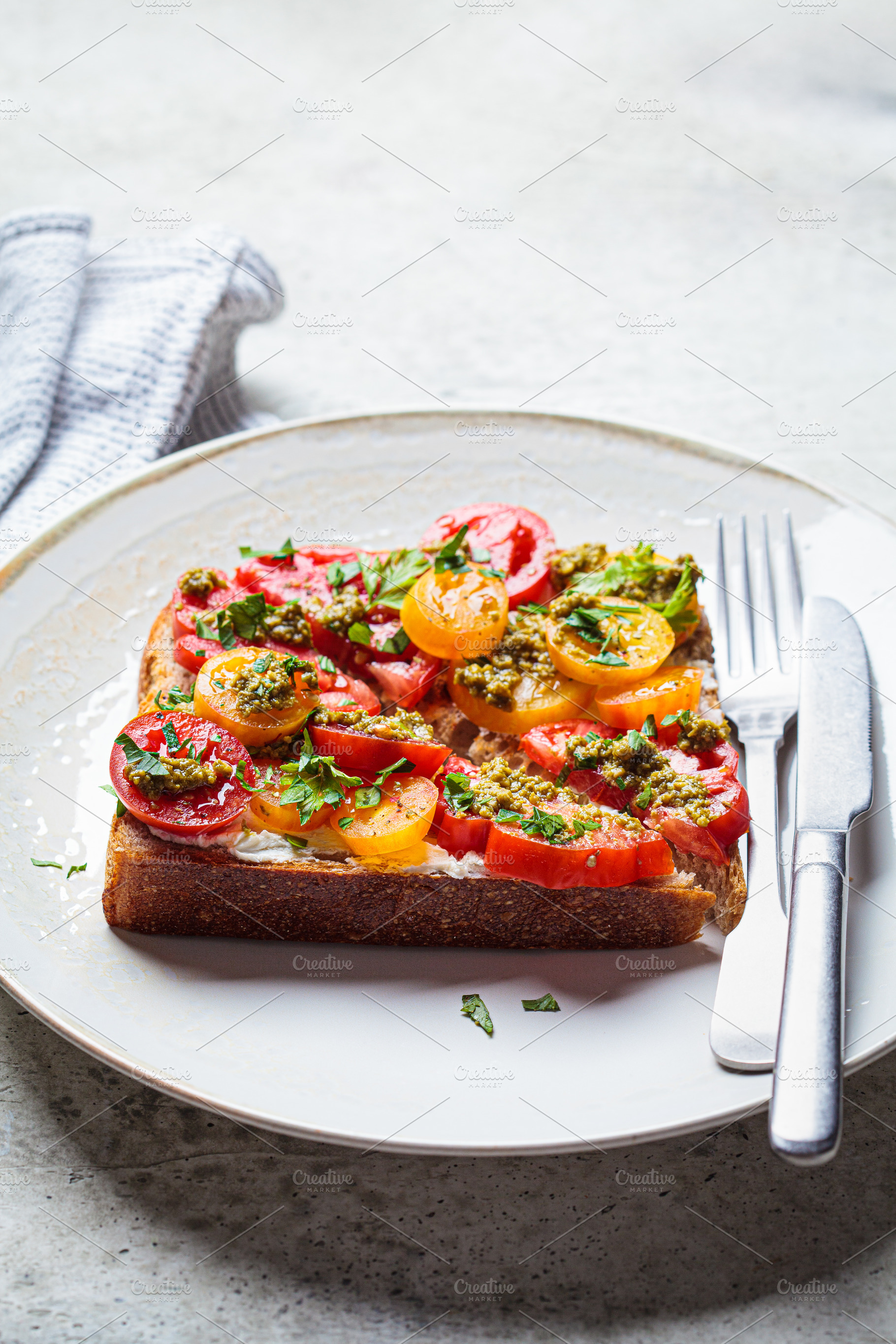 Toast with tomato, pesto and cheese, a Food & Drink Photo by vaaseenaa