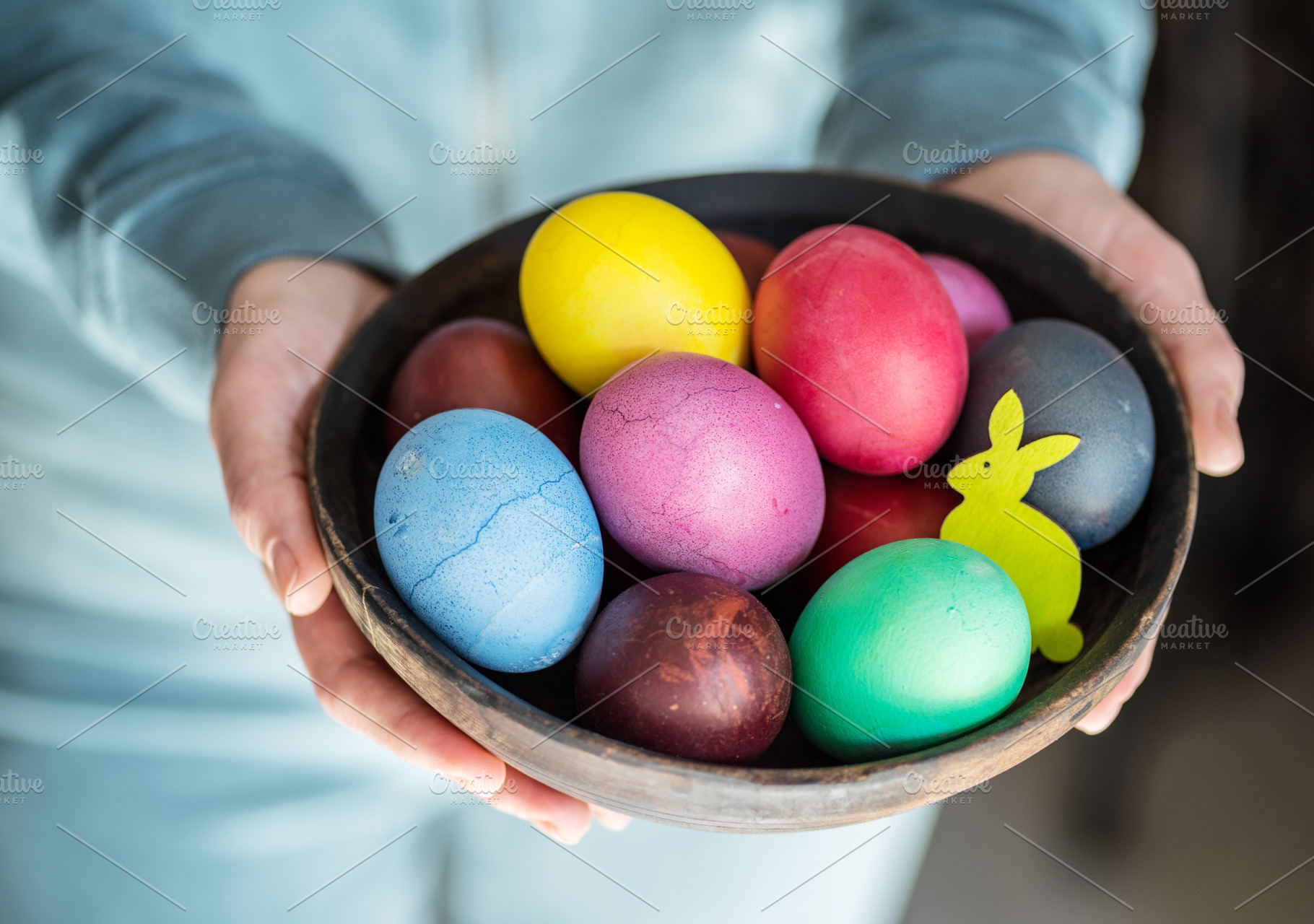 Colorful Easter eggs in bowl in woma, a Photo by Volff