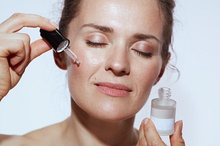 relaxed modern woman with cosmetic elixir, a Beauty & Fashion Photo by Alliance Images