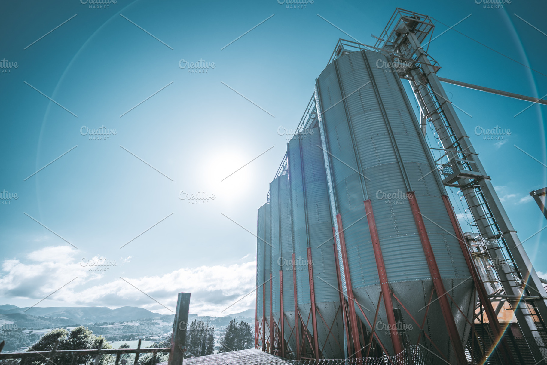 Grain silos at feed mill plant, an Industrial Photo by SkyNext