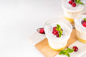 Christmas portioned cheesecakes in glass, a Food & Drink Photo by Rimma