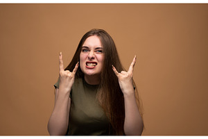 Young woman showing rock and roll, a Person Photo by volodymyrshtun13795