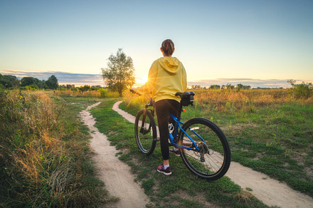 Woman riding a mountain bike in cross country road in summer, a Sports & Recreation Photo by den-belitsky
