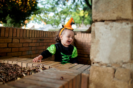 Baby in halloween costume playing ou