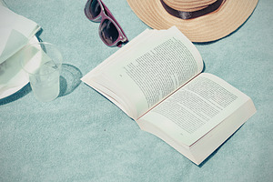 A lady reading on the beach 