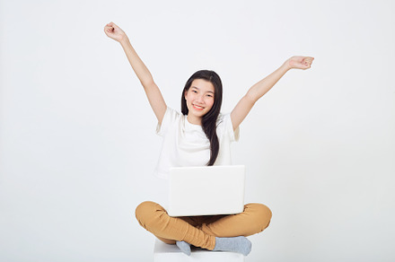 woman sitting using laptop sitting on gray background, a Person Photo by 1981 Rustic studio kan