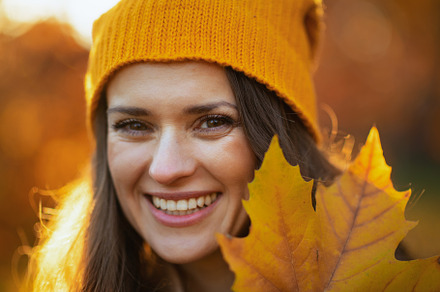 happy elegant woman in brown coat and yellow hat, a Person Photo by Alliance Images