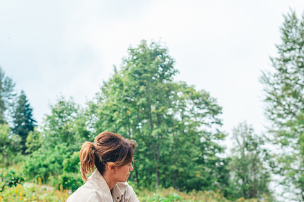 Beautiful happy woman in mountains in the background of fog, a Person Photo by travnikovstudio