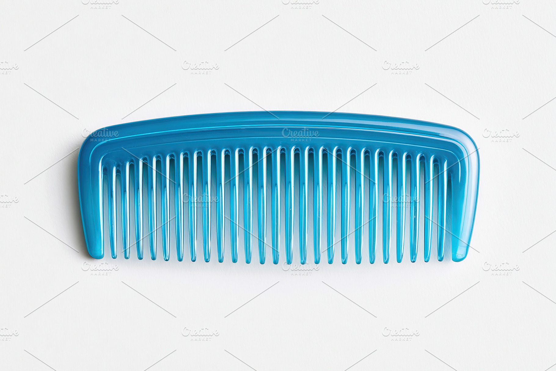 Blue plastic comb with fine teeth placed on a plain background for styling and, a Beauty & Fashion Photo by AlyaAnd