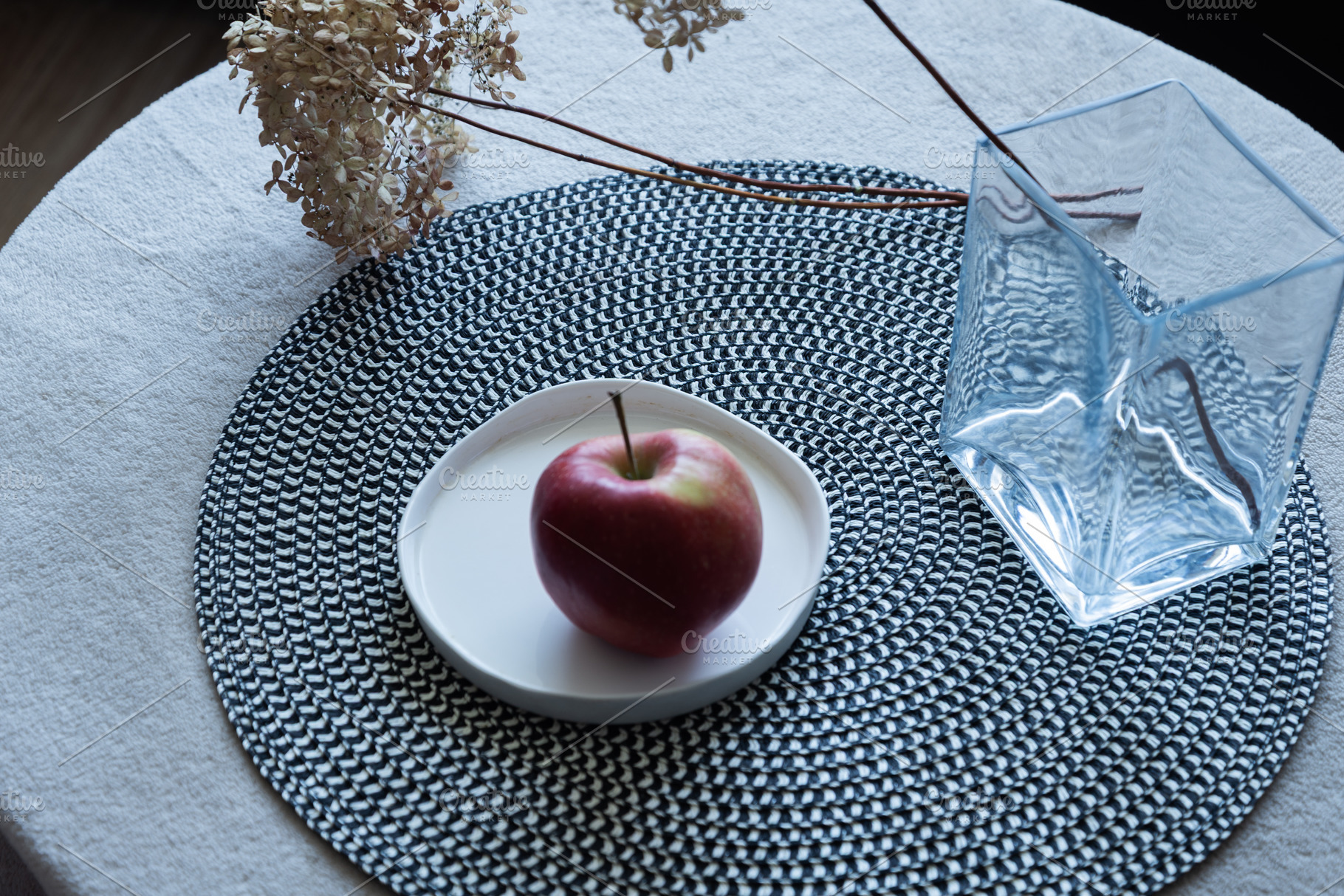 Red apple on ceramic plate on table, an Industrial Photo by MDBildes