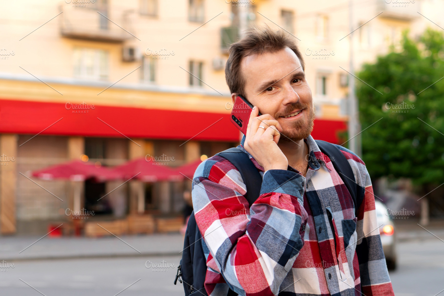Smiling young man talking on phone, a Person Photo by Elena Vagengeim
