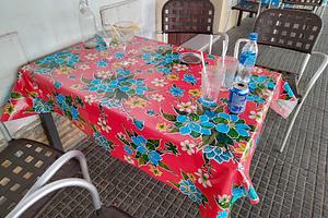 Colorful tablecloth in rustic dining setting, a Food & Drink Photo by DanFLCreativo