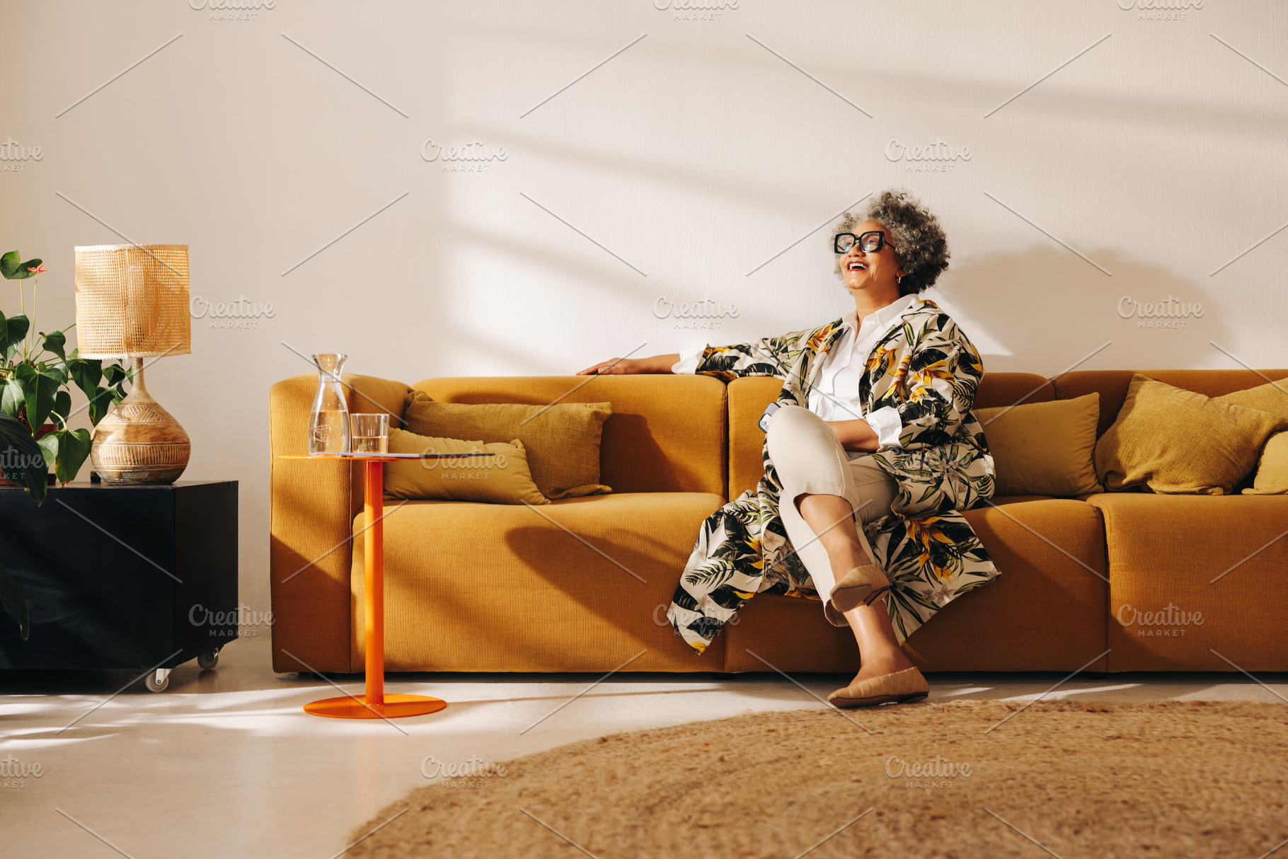 Mature businesswoman smiling happily in an office lobby, a Person Photo by Jacob Lund