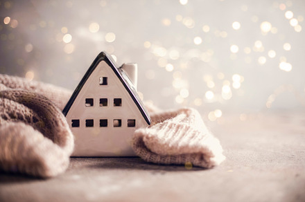 Ceramic house insulated by warm sweater. Winter holiday card, a Holiday Photo by Anikona