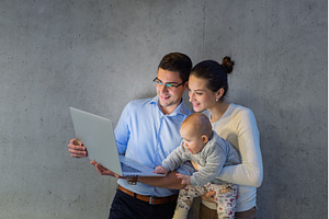 Mother with baby sitting next to, a Business Photo by HalfPoint