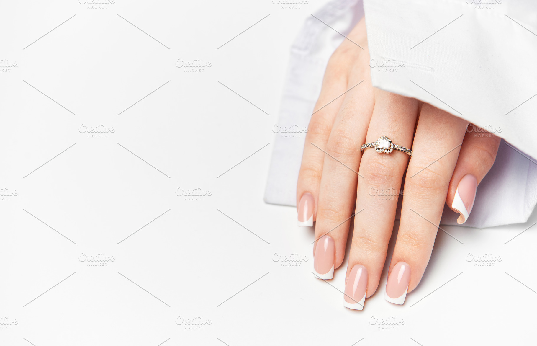 Woman hand showing french manicure and elegant ring on white bac, a Beauty & Fashion Photo by Olena Rudo