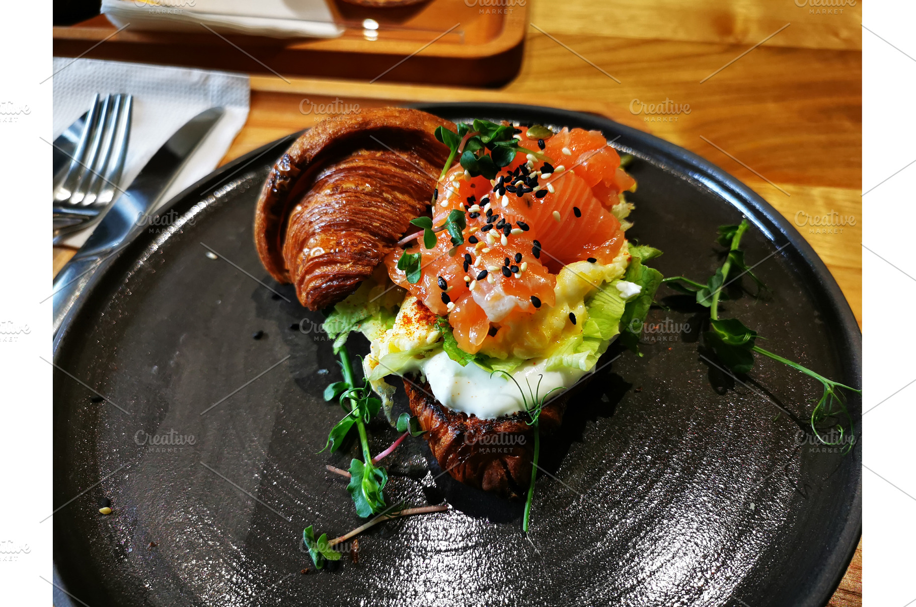 Croissant with salmon, egg, a Food & Drink Photo by sceptical cactus