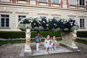 Children playing beneath a large floral arrangement in Lancut, Poland garden se, a Photo by AS photostudio