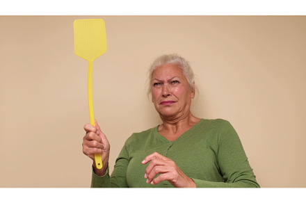 An elderly European woman is trying