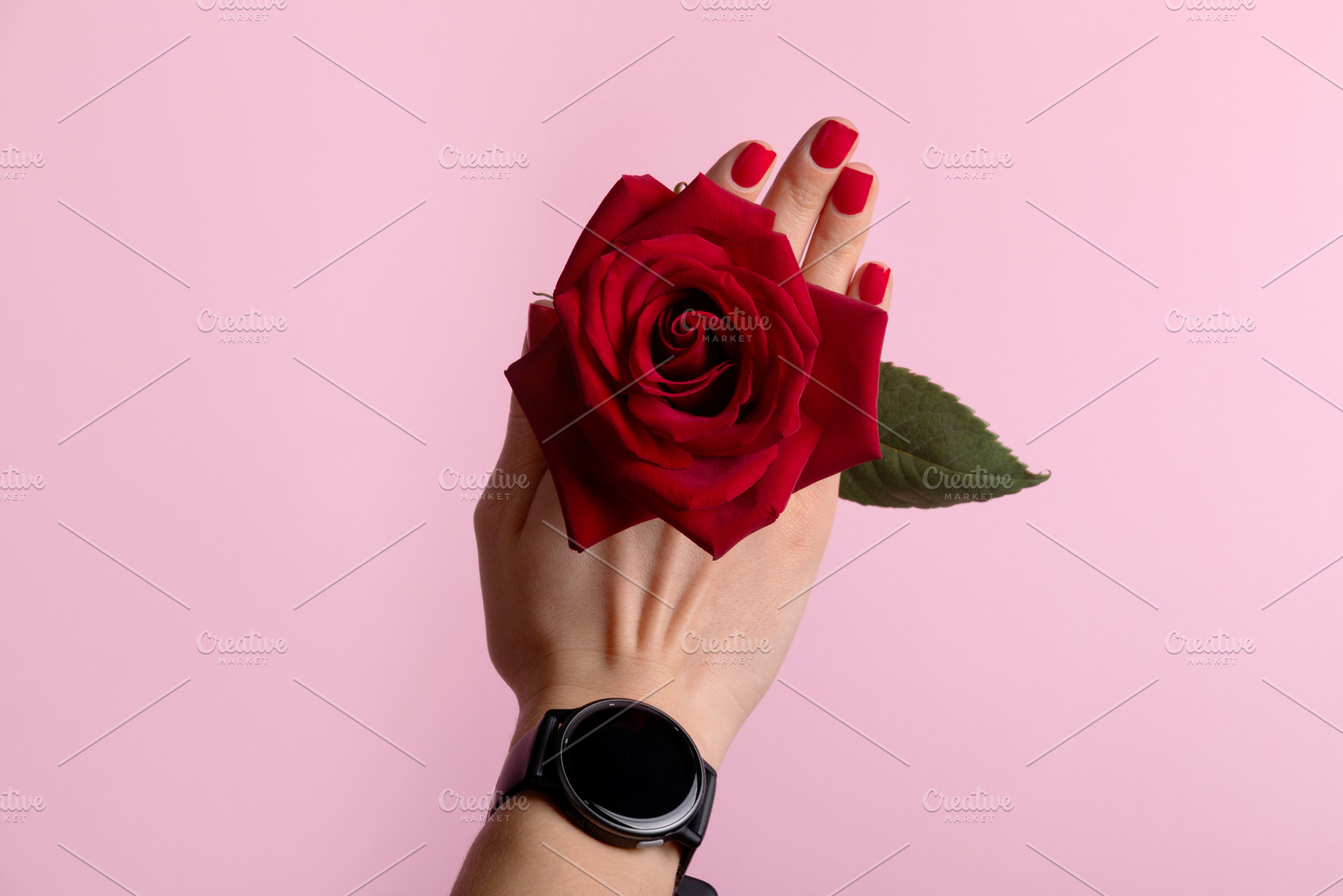 Close-up of a woman's hand with red manicure holding a vibrant r, a Photo by Ales Munt