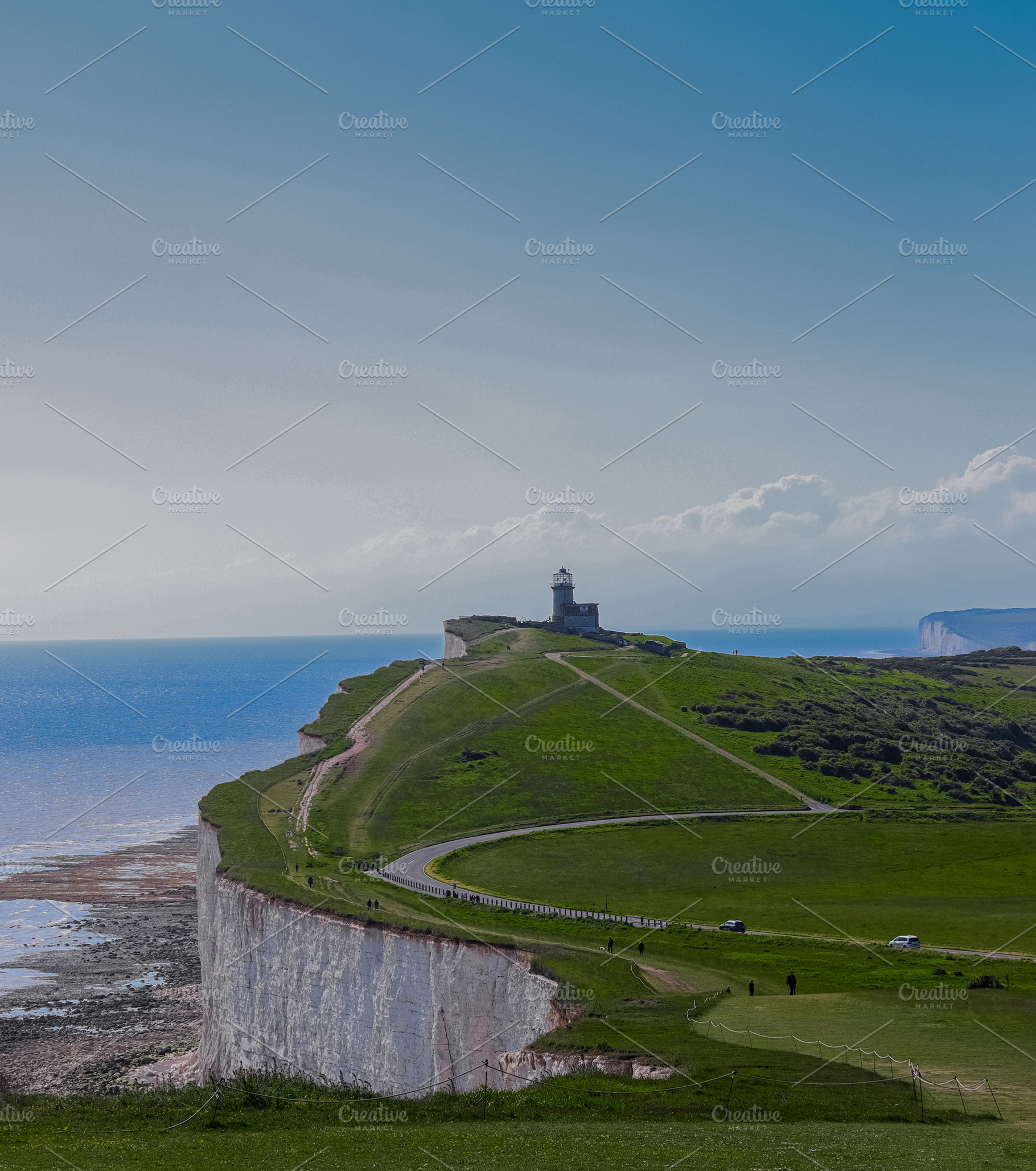 Belle Tout lighthouse providing guidance from a dramatic cliff, facing the vast, a Photo by Studio ANNA
