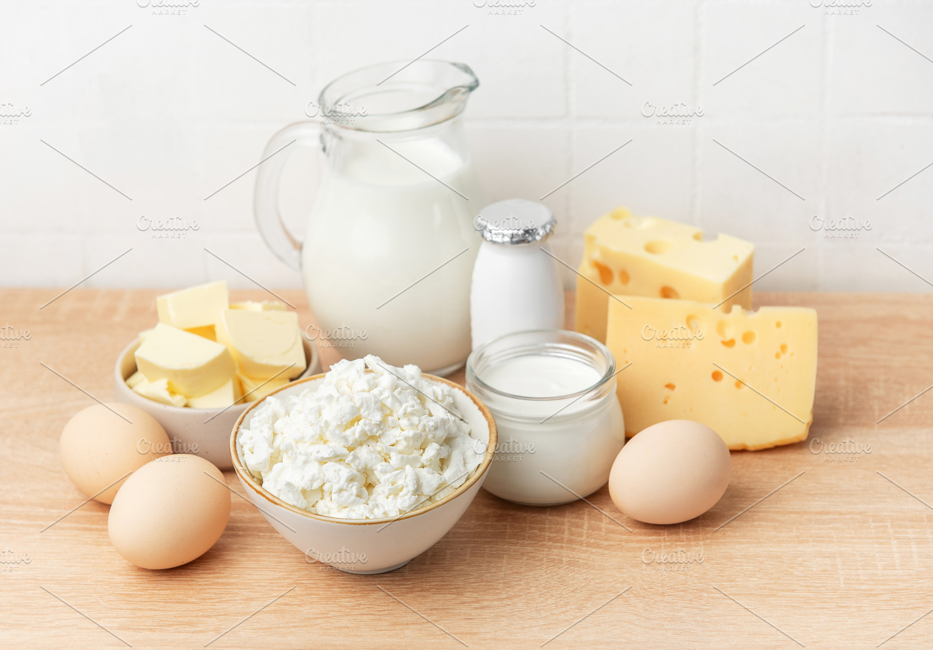 Fresh dairy products and eggs on wooden table, a Food & Drink Photo by Olena Rudo