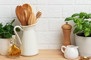 Kitchen utensils, plants and spices creating a cozy atmosphere o, a Food & Drink Photo by Olena Rudo