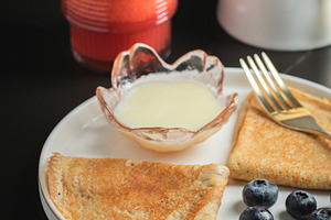 Pancakes with blueberry and honey on a white plate, a Food & Drink Photo by Budarinphoto