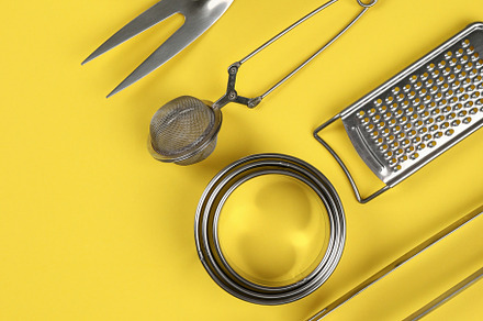 Kitchen utensil on yellow background, space for text, a Food & Drink Photo by AtlasStudio PRO