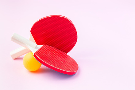 Children mini rackets ping pong or table tennis and orange ball on pink backgro, a Sports & Recreation Photo by iuliia_n