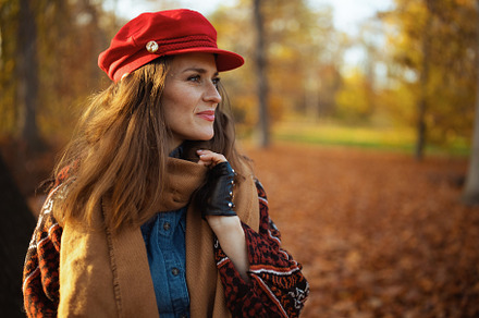 pensive modern 40 years old woman in red hat with scarf, a Person Photo by Alliance Images