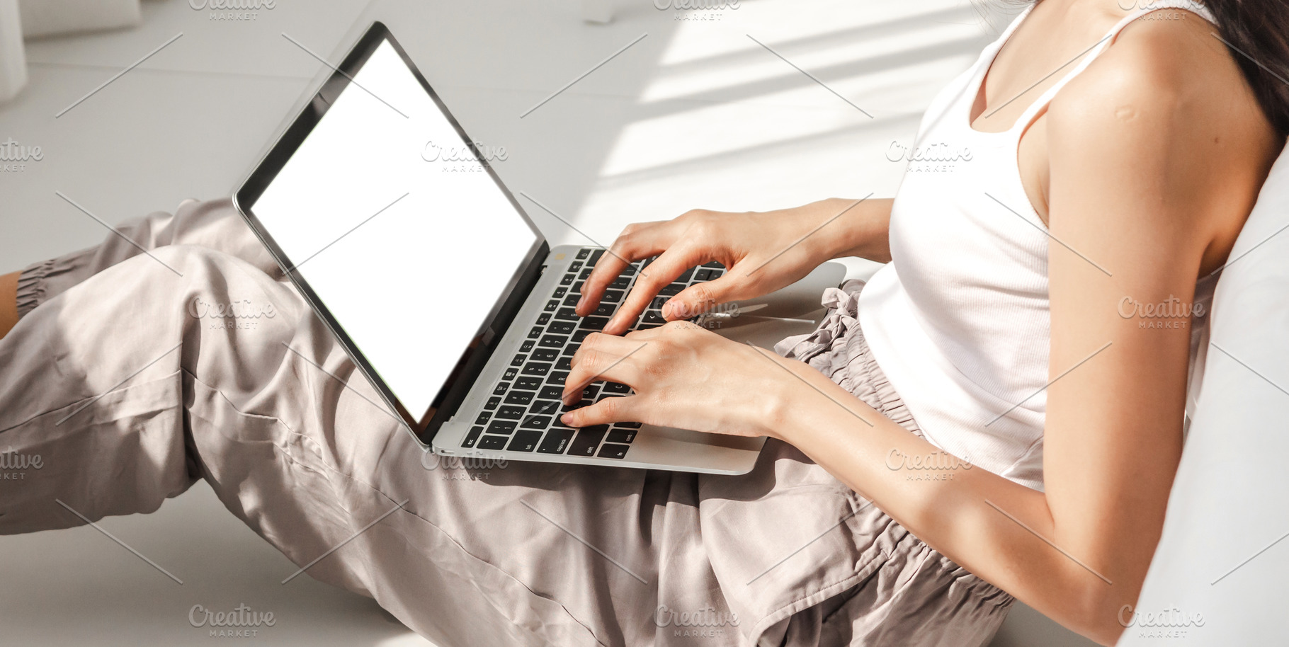 Asian woman relaxing using laptop computer working with white mo, a Photo by Art_Photo