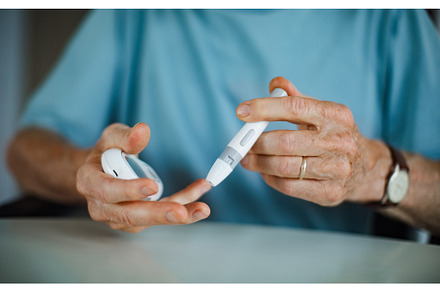 Diabetic senior man on wheelchair, a Health & Medical Photo by HalfPoint