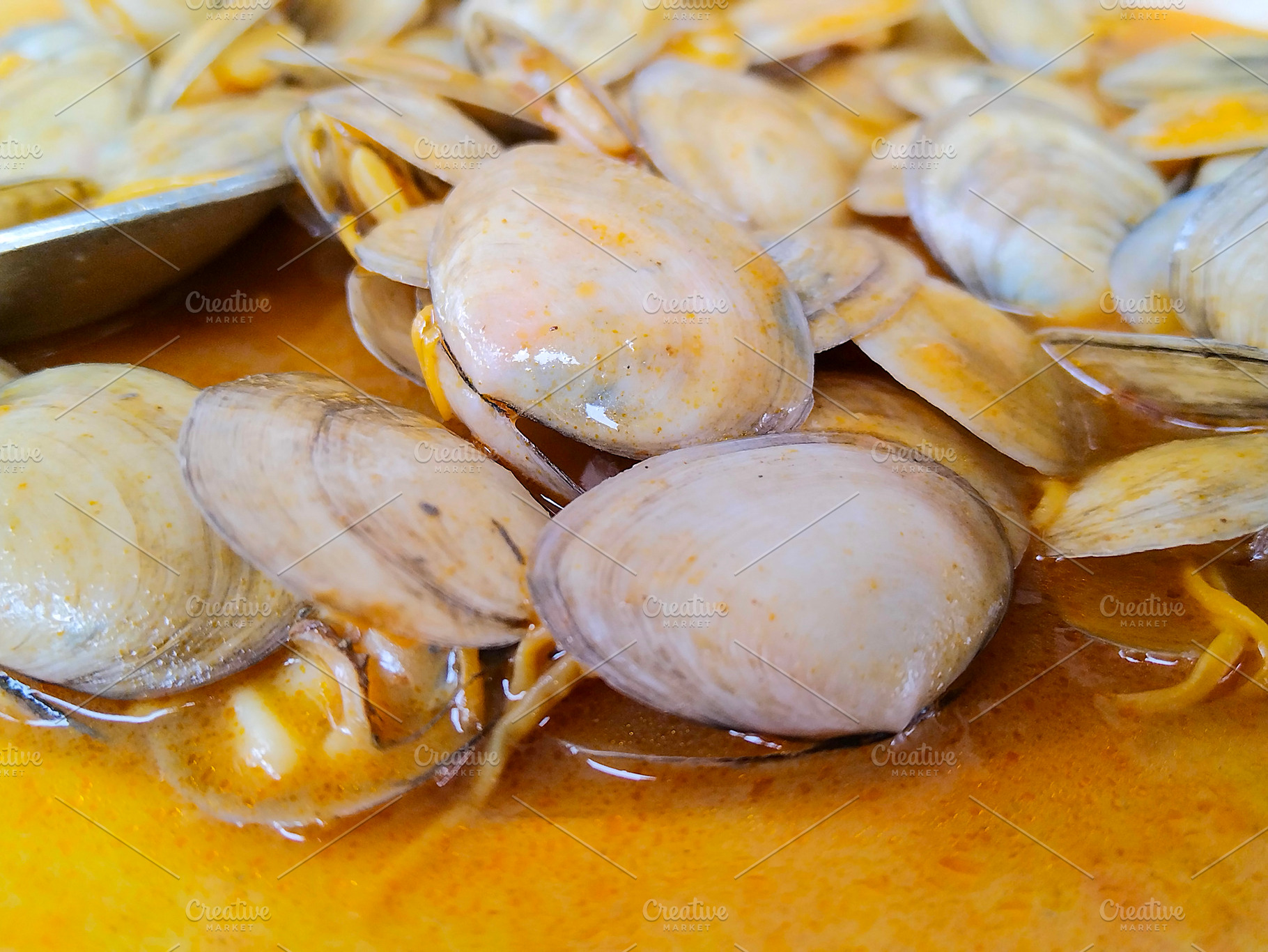 Clams in yellow sauce close-up, a Food & Drink Photo by DanFLCreativo