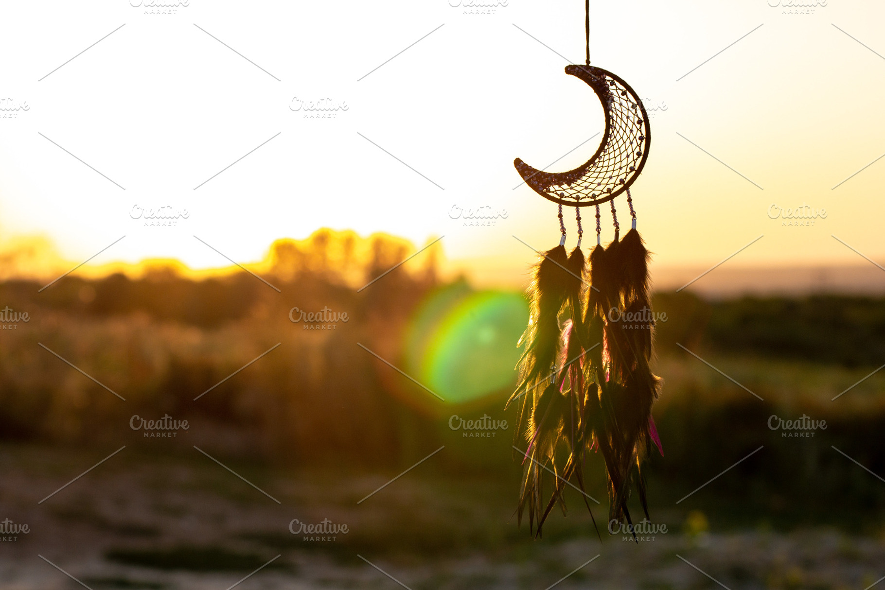 Handmade dream catcher with feathers threads and beads rope hanging, a Background Photo by dashtik