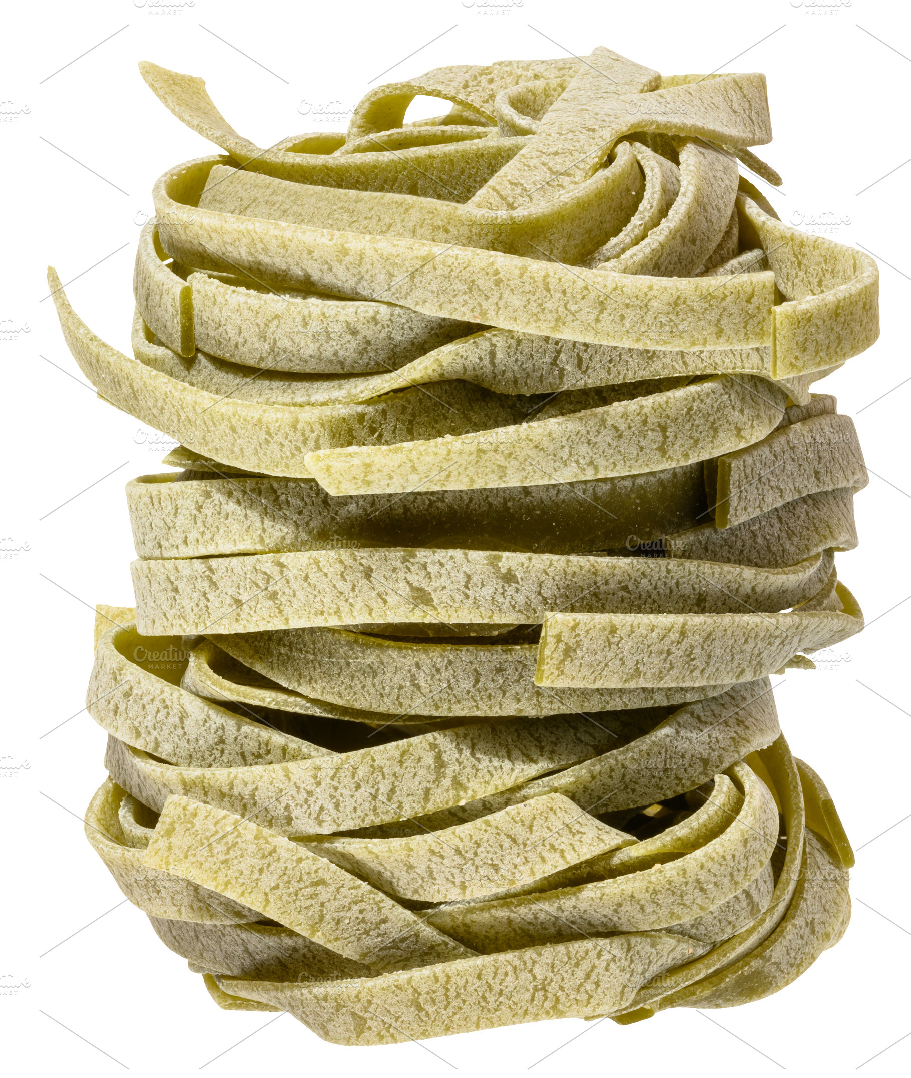 Nest of dry green egg pasta tagliatelle with spinach, isolated b, a Food & Drink Photo by ndanko