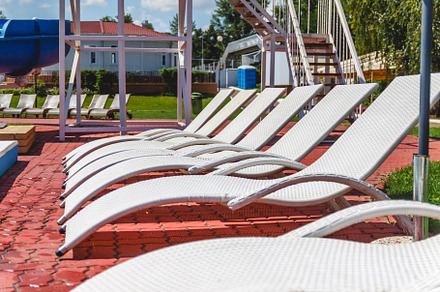 A number of many light loungers near the pool with a slide, a Sports & Recreation Photo by TanaCh