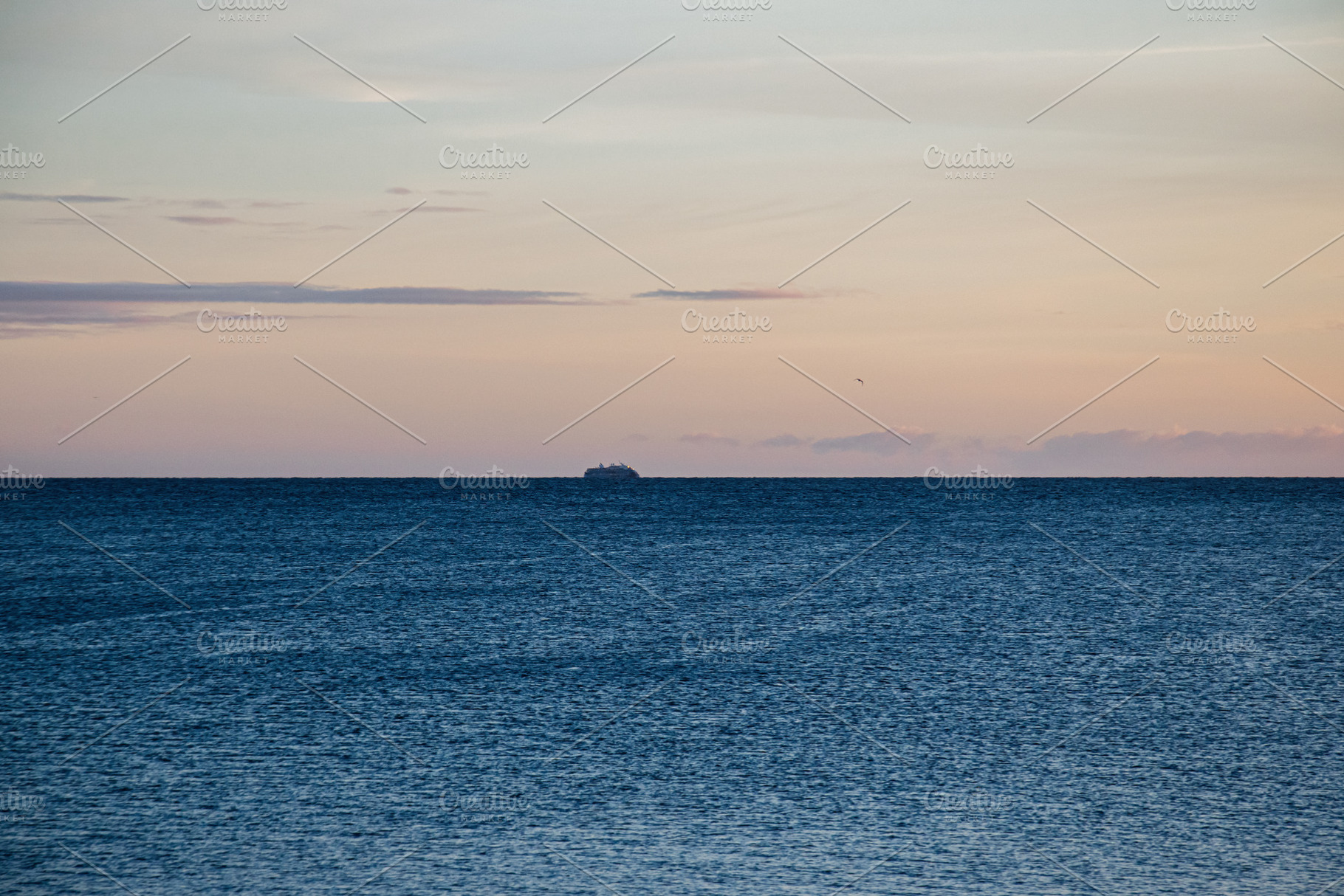 Serene ocean view during sunset with distant vessel near Iceland's horizon, a Nature Photo by AS photostudio