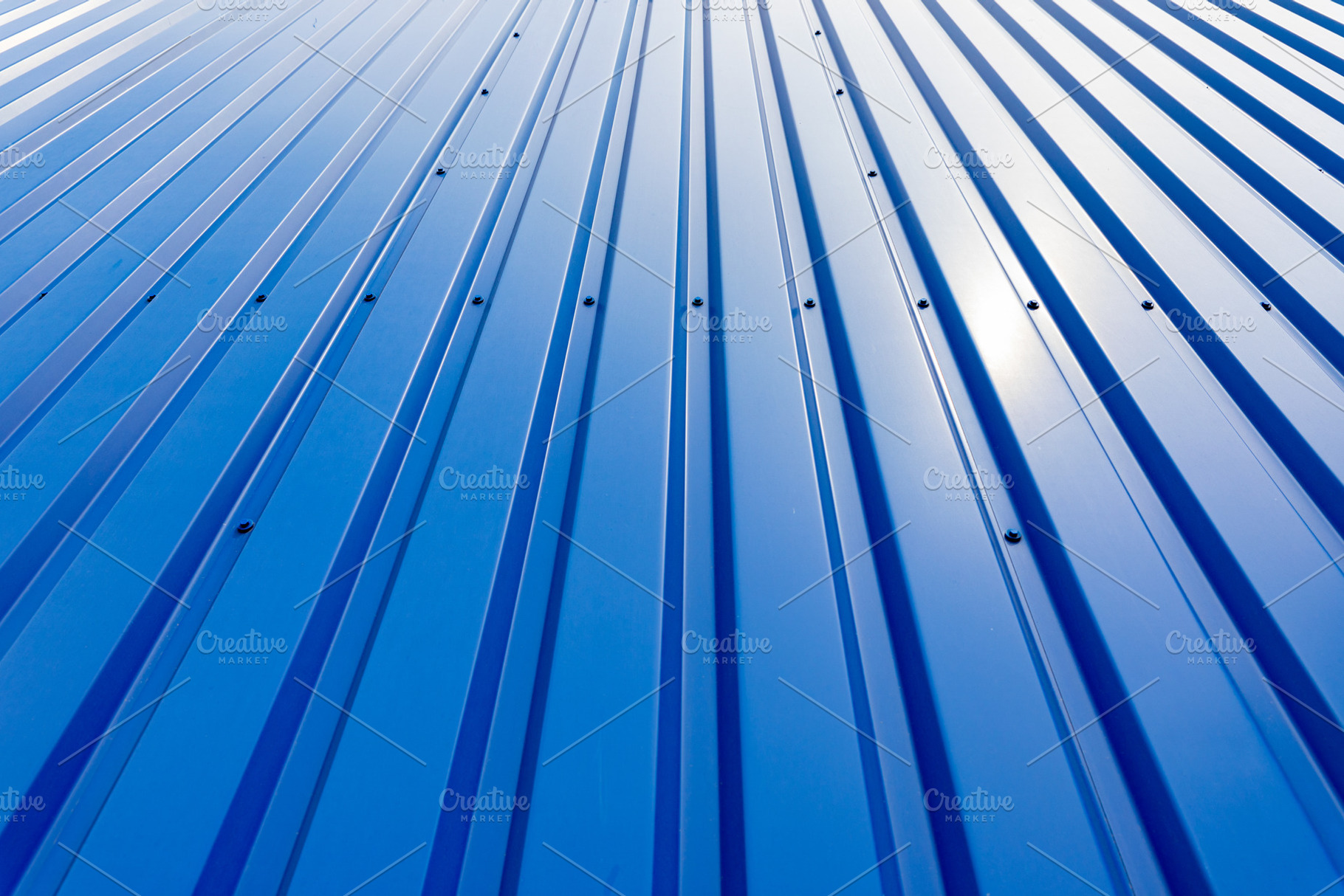 Close-up of blue corrugated metal wall with sunlight reflection,, a Background Photo by Ales Munt