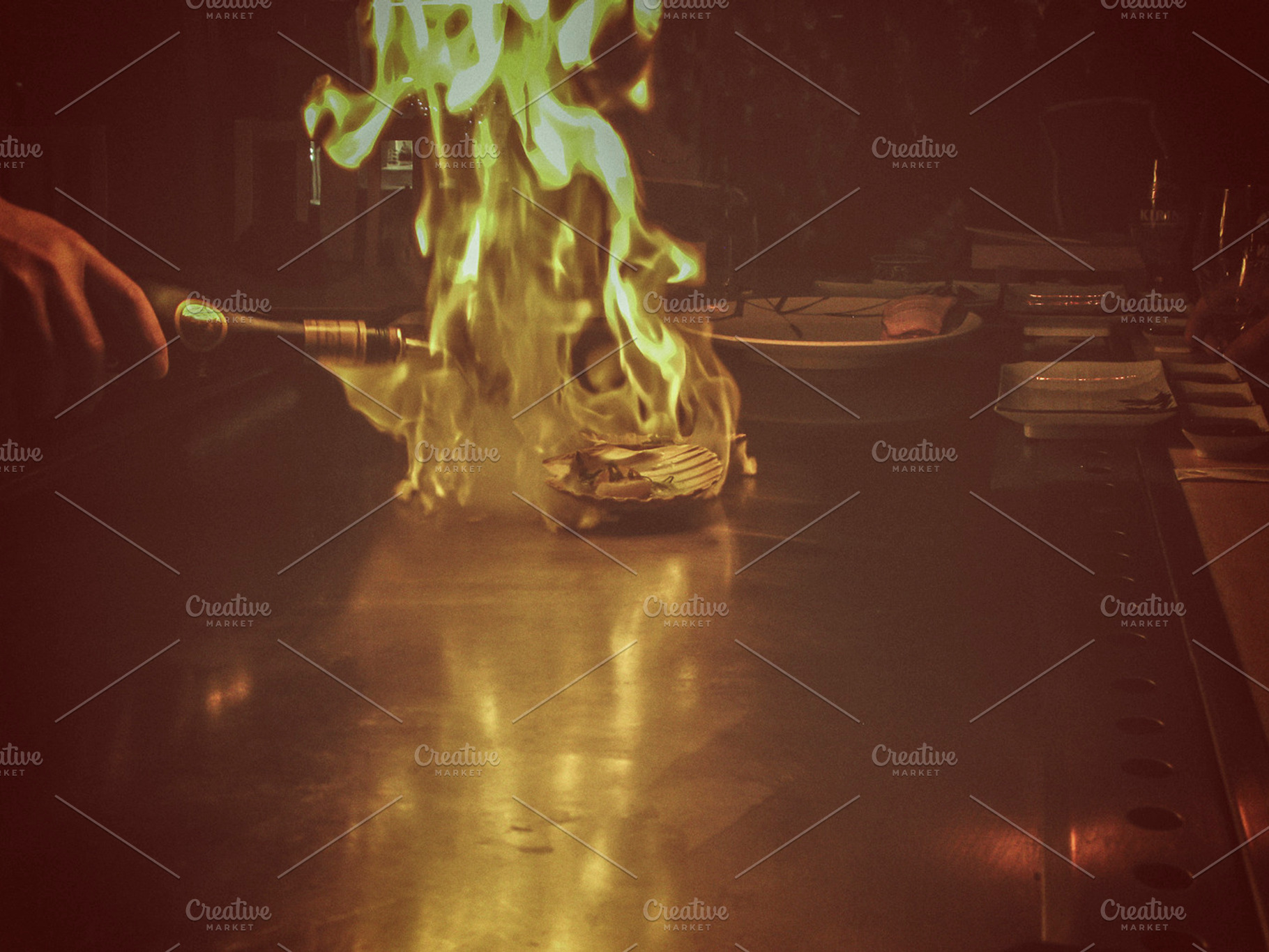 Flambe scallops on a grill, a Photo by Patricia Hofmeester