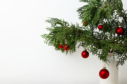 Christmas ornaments creating a festive display, vase with thuja branches, a Photo by matucha
