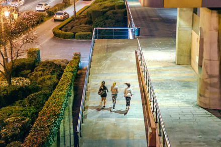 Women friends runners training together on the city at night