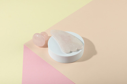 Face care concept with gua sha on soft three tone background, a Beauty & Fashion Photo by AtlasStudio PRO