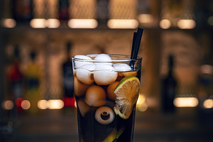 Refreshing halloween cocktail featuring a spooky eyeball and ice, a Photo by Grafvision photography
