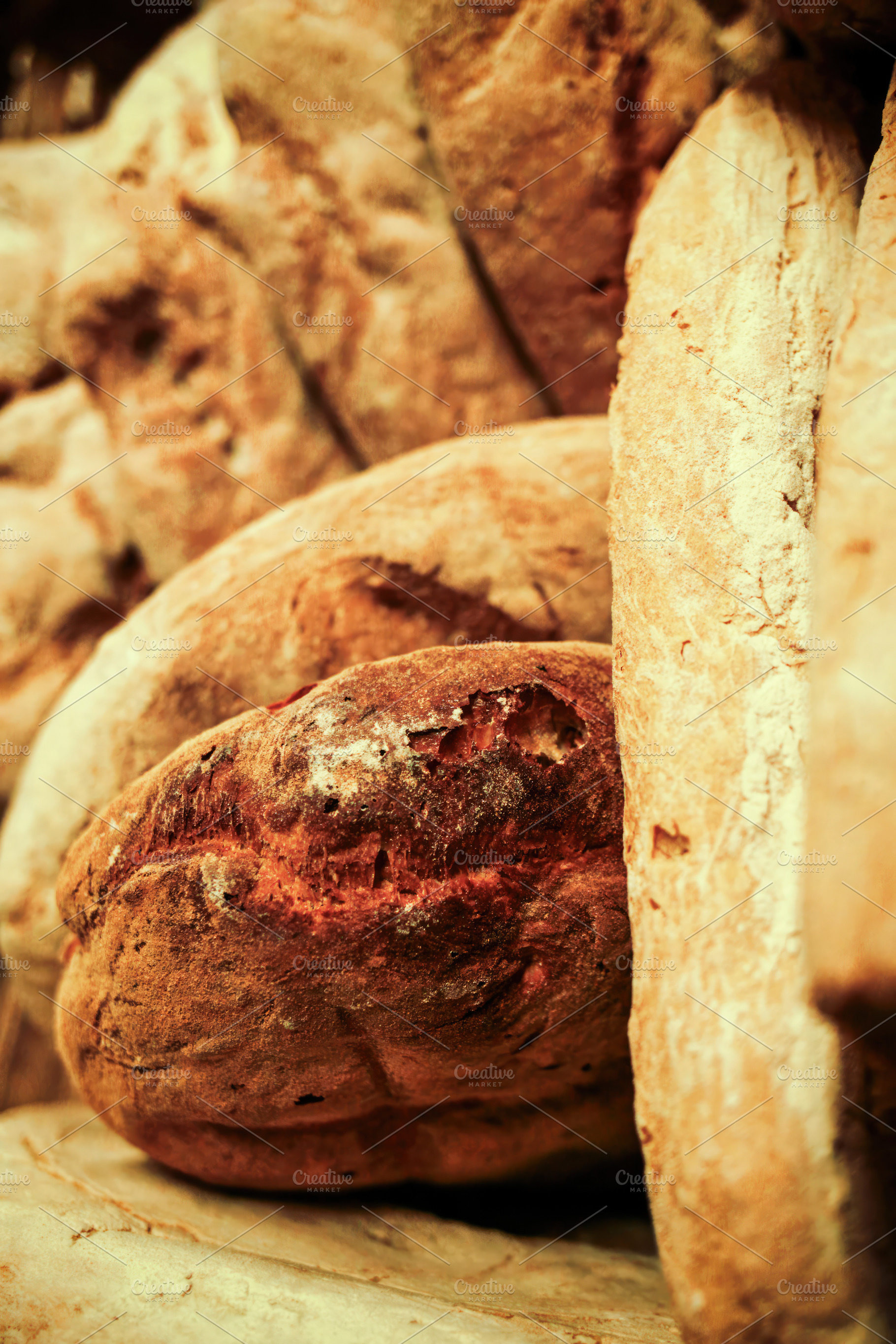 Freshly baked loaves of bread resting on a wooden shelf in a bakery, an Abstract Photo by Antonio Gravante Market
