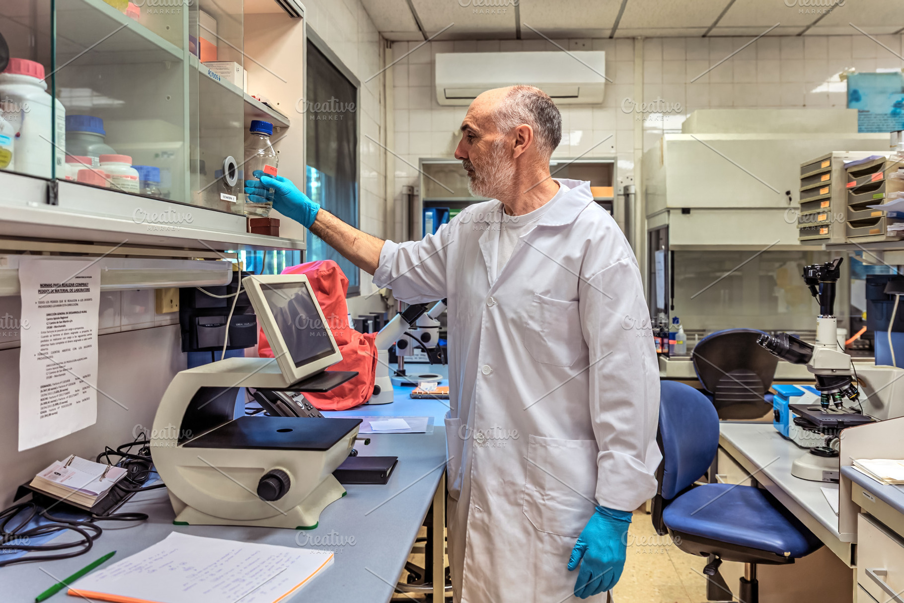 Scientist in a laboratory selecting, a Health & Medical Photo by Perpis