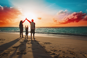 Happy family on sunset beach stock photo containing baby and beach