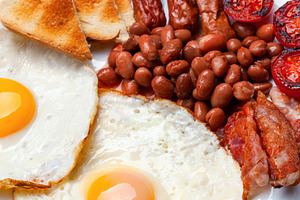 Full English breakfast with fried eggs, sausages, bacon, beans and toasts, a Food & Drink Photo by Antonio Gravante Market